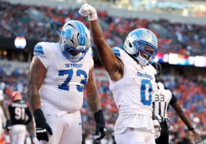 Jahmyr Gibbs #0 of the Detroit Lions celebrates a touchdown against the Cincinnati Bengals.