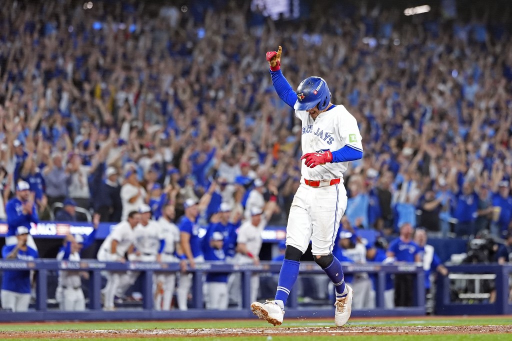 Ernie Clement #22 of the Toronto Blue Jays celebrates after scoring a run against the Seattle Mariners.