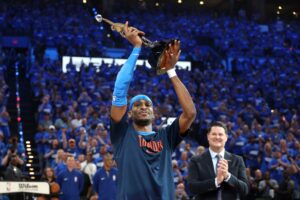 Shai Gilgeous-Alexander of the Oklahoma City Thunder accepts the MVP Michael Jordan Trophy.