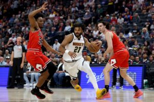 Jamal Murray #27 of the Denver Nuggets drives to the basket against Isaac Okoro #35 and Josh Giddey #3 of the Chicago Bulls