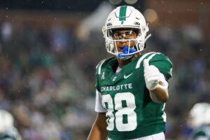 Miles Burris #88 of the Charlotte 49ers checks in with a referee during the game against the North Carolina Tar Heels.