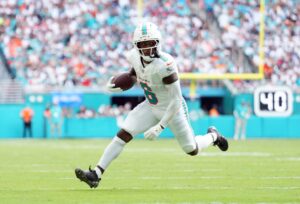 Wide receiver Malik Washington #6 of the Miami Dolphins carries the ball during the game against the New England Patriots.