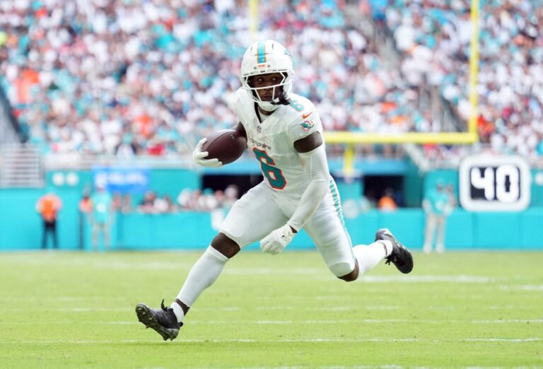 Wide receiver Malik Washington #6 of the Miami Dolphins carries the ball during the game against the New England Patriots.