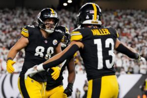 Pat Freiermuth #88 of the Pittsburgh Steelers celebrates with Scott Miller #13 after scoring a touchdown against the Cincinnati Bengals.