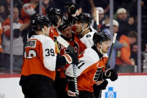 Travis Konecny #11 of the Philadelphia Flyers celebrates his goal with teammates against the Seattle Kraken.