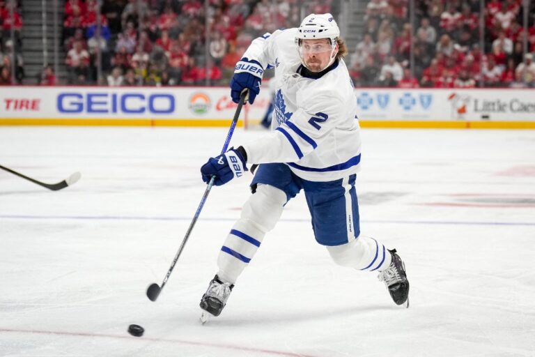 Simon Benoit #2 of the Toronto Maple Leafs shoots the puck against the Detroit Red Wings