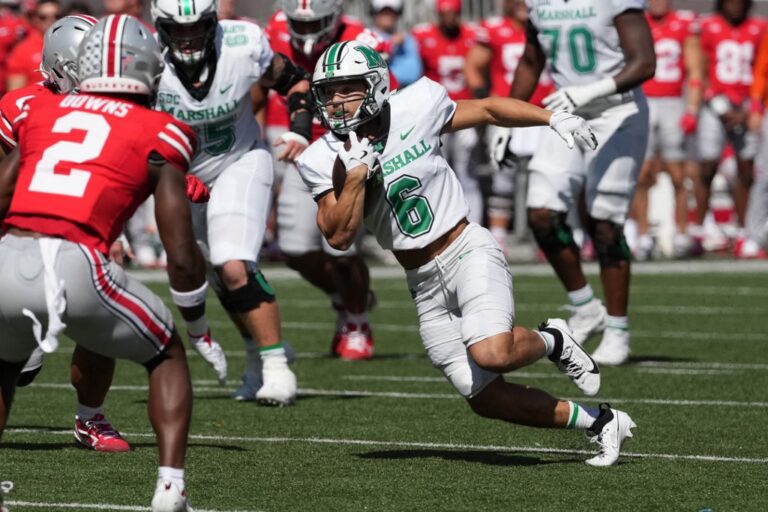 Running back Jordan Houston #6 of the Marshall Thundering Herd carries the ball during the first quarter against the Ohio State Buckeyes
