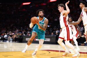 Miles Bridges #0 of the Charlotte Hornets goes to the basket against Pelle Larsson #9 of the Miami Heat