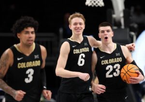Trevor Baskin #6, Andrej Jakimovski #23and Julian Hammond III #3 of the Colorado Buffaloes react as the Buffaloes defeat the West Virginia Mountaineers.