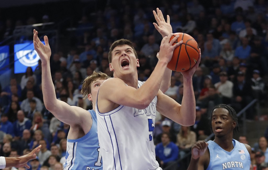 Mihailo Boskovic #5 of the Brigham Young Cougars drives to the basket against Henri Veesaar #13 of the North Carolina Tar Heels. College basketball picks today