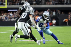 The cover for this Thursday night football picks article shows CeeDee Lamb #88 of the Dallas Cowboys running the ball after a catch against the Las Vegas Raiders.