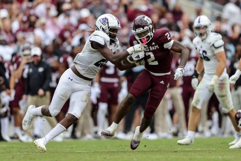 The cover for this Saturday college football article shows Rueben Owens #2 of the Texas A&M Aggies running the ball while being tackled by Izaiah Kelley #25 of the Abilene Christian Wildcats