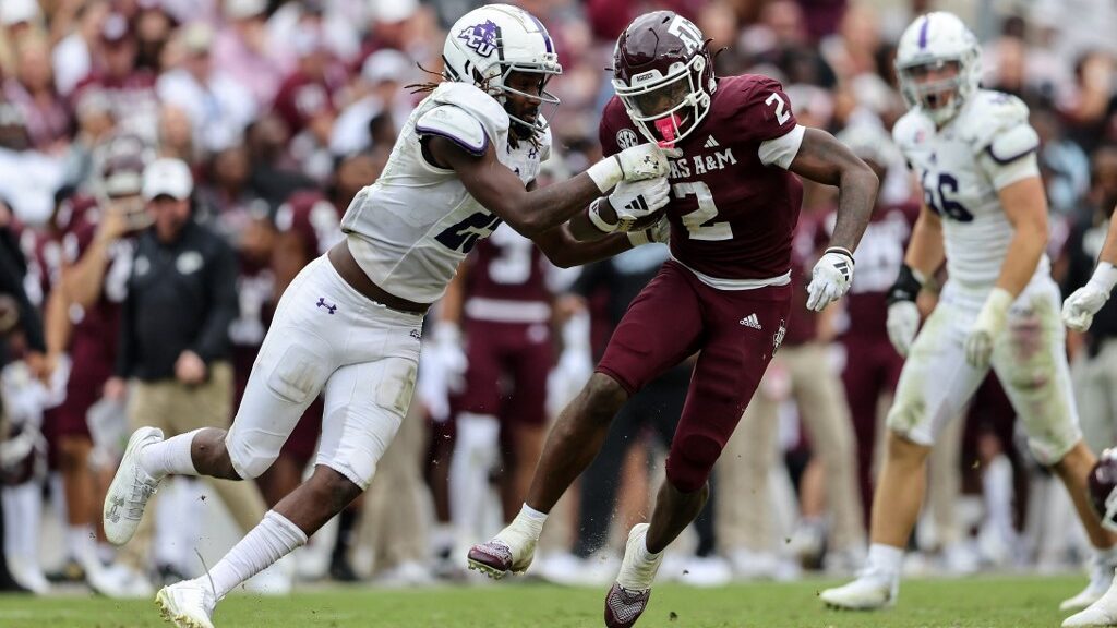 Rueben-Owens-2-of-the-Texas-AM-Aggies-runs-the-ball-while-being-tackled-aspect-ratio-16-9