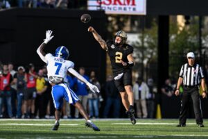 The cover for this NCAAF Heisman Trophy odds article shows Diego Pavia #2 of the Vanderbilt Commodores passing the ball in the first half against the Kentucky Wildcats.