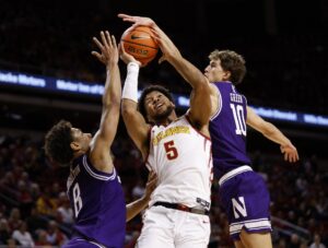 The cover for this college basketball picks today shows guard Max Green #10 of the Northwestern Wildcats blocking a shot by forward Joshua Jefferson #5 of the Iowa State Cyclones as forward Tre Singleton #8 of the Northwestern Wildcats defends