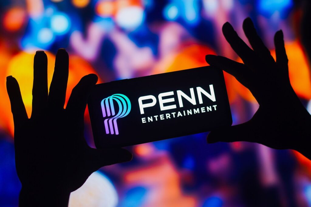 The logo for Penn Entertainment is seen on the screen of a smartphone.