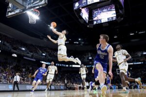 The cover for this college basketball picks today article shows Caleb Grill #31 of the Missouri Tigers shoots a layup against the Drake Bulldogs