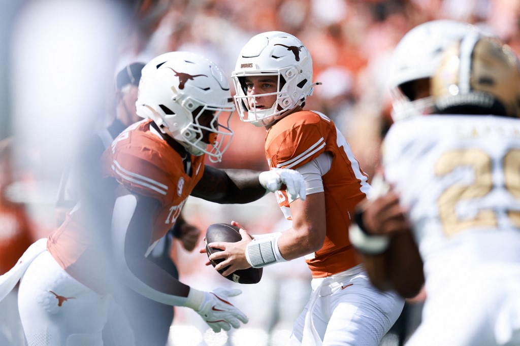 The cover for this College football player props week 12 article shows Arch Manning #16 of the Texas Longhorns looking to pass from the fake handoff during the first quarter of the game against the Vanderbilt Commodores.