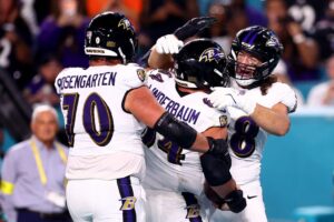 The Baltimore Ravens, featured in our top NFL picks week 11, celebrate against the Miami Dolphins.