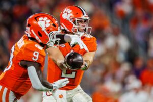 Cade Klubnik hands the ball off to Gideon Davidson of the Clemson Tigers, featured in our Friday night college football preview, during the game against the Florida State Seminoles.