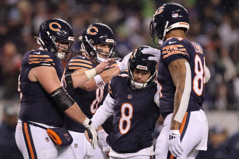 Cairo Santos #8 of the Chicago Bears, featured in our Sunday morning football picks, celebrates a field goal with teammates against the Seattle Seahawks.