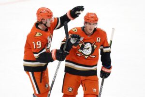 Ryan Strome of the Anaheim Ducks congratulates Troy Terry, featured in our NHL anytime goal scorer props, after his empty net goal against the Vancouver Canucks.
