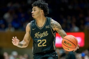 Chris Johnson #22 of the UCF Knights, featured in our College basketball picks today, brings the ball up court against the Duke Blue Devils.
