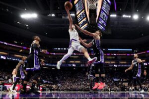 Los Angeles Lakers' Austin Reaves, featured in our NBA player props today, goes up for a shot against the Sacramento Kings.