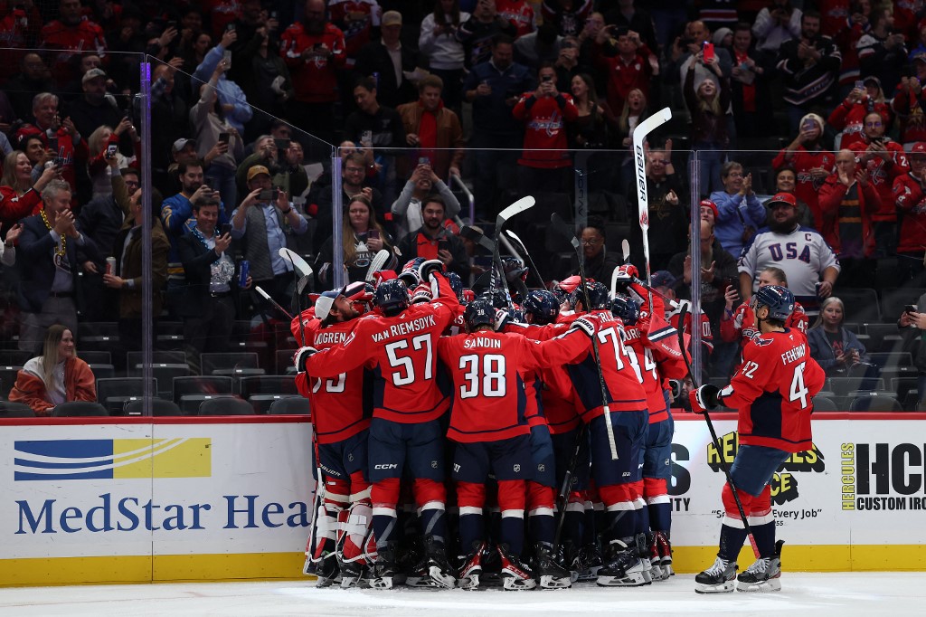 Alex Ovechkin of the Washington Capitals, a team featured in our NHL picks today, celebrates with teammates after scoring against the St. Louis Blues.