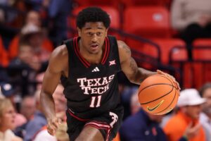 Jaylen Petty #11 of the Texas Tech Red Raiders, featured in our College Basketball picks today, dribbles up the court.