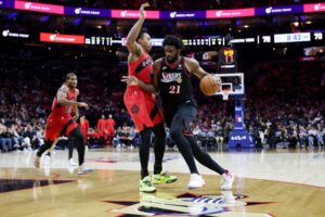 The cover for this NBA player props today article shows Joel Embiid #21 of the Philadelphia 76ers in action against Ochai Agbaji #30 of the Toronto Raptors.
