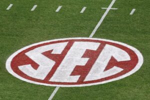 A crimson SEC logo is seen on the turf before the game between the Texas Longhorns and the Oklahoma Sooners at Cotton Bowl in Dallas, Texas.