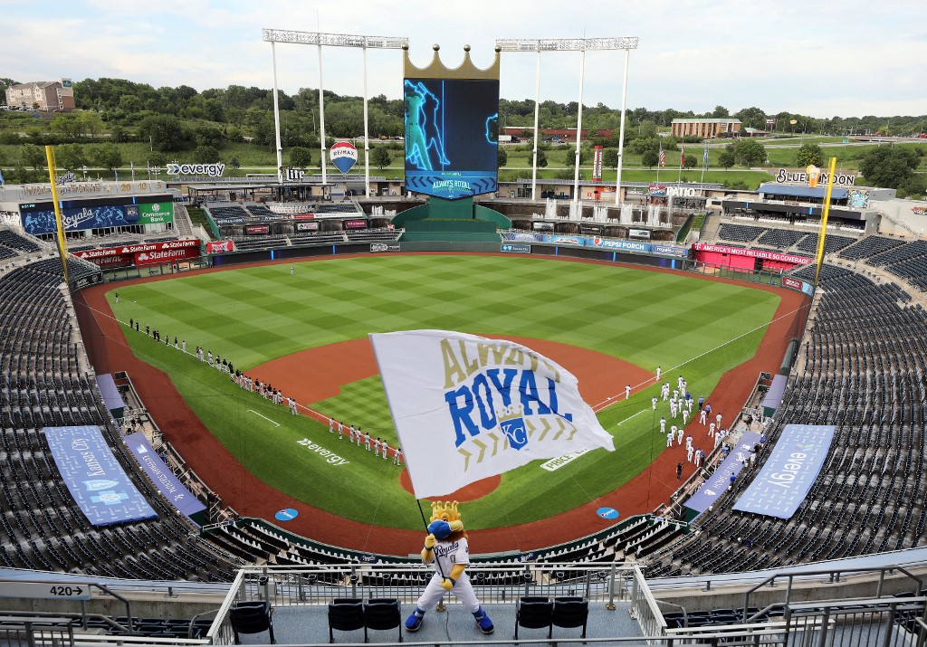 The Kansas City Royals mascot Sluggerrr waves a flag during player introductions prior at Kauffman Stadium in Kansas City, Missouri.