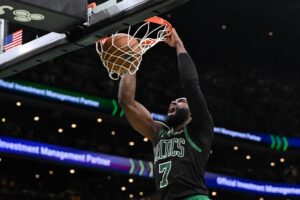 Jaylen Brown #7 of the Boston Celtics dunks and scores against the Detroit Pistons.