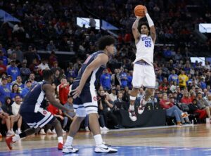 The cover for this college basketball picks today article shows Skyy Clark #55 of the UCLA Bruins shooting a jumper in front of Koa Peat #10 and Dwayne Aristode #2 of the Arizona Wildcats during a 69-65 Arizona Wildcats win over the UCLA Bruins.