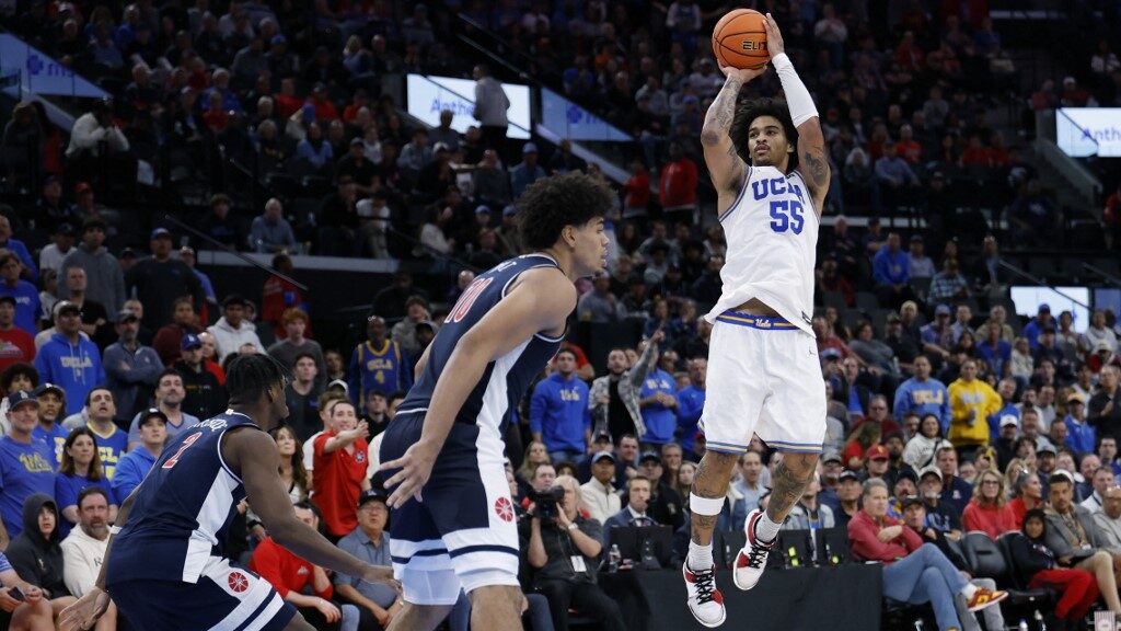 Skyy-Clark-55-of-the-UCLA-Bruins-shoots-a-jumper-in-front-of-Koa-Peat-aspect-ratio-16-9