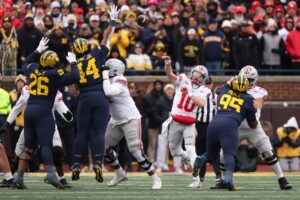 The cover for this College football player props week 15 article shows Julian Sayin #10 of the Ohio State Buckeyes playing against the Michigan Wolverines.
