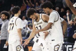 Devin Tillis #11 and Jurian Dixon #24 of the UC Irvine Anteaters celebrate in the closing seconds of the semifinal game of the Big West men's basketball tournament against the Cal Poly Mustangs.