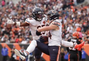 Colston Loveland #84 of the Chicago Bears celebrates a touchdown with Kyle Monangai #25 against the Cincinnati Bengals.
