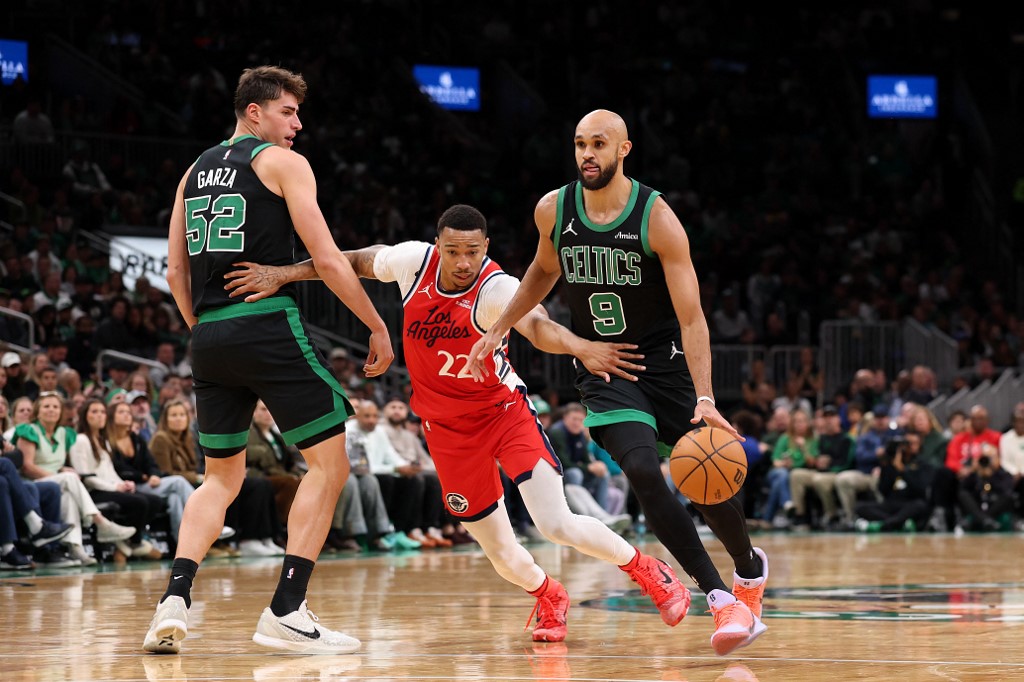 The cover for this NBA player props today article shows Derrick White #9 of the Boston Celtics dribbling past Jordan Miller #22 of the LA Clippers.