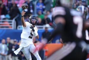 Dante Moore #5 of the Oregon Ducks passes against the Texas Tech Red Raiders.