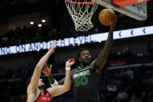 Julius Randle #30 of the Minnesota Timberwolves dunks the ball over Karlo Matkovic #17 of the New Orleans Pelicans.