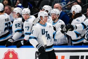 John Marino #6 of the Utah Mammoth is congratulated after scoring a goal against the Vancouver Canucks.