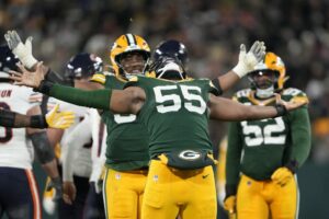 Kingsley Enagbare #55 of the Green Bay Packers celebrates after sacking Caleb Williams #18 of the Chicago Bears.