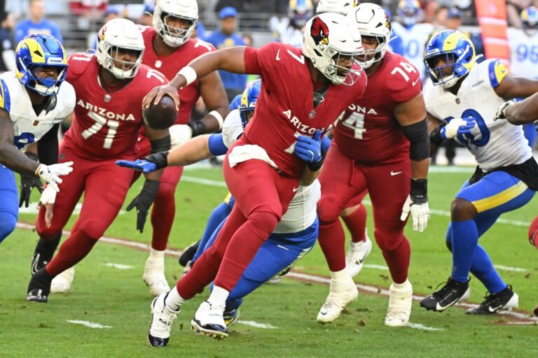 Jacoby Brissett #7 of the Arizona Cardinals escapes a tackle by Braden Fiske #55 of the Los Angeles Rams.