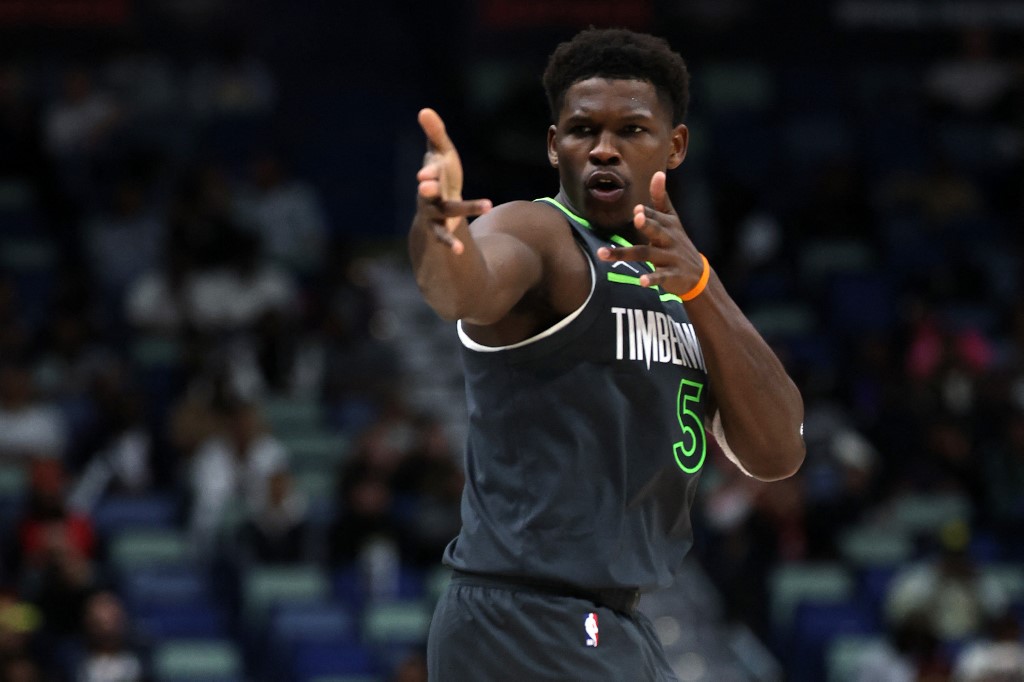 The cover for this NBA player props today article shows Anthony Edwards #5 of the Minnesota Timberwolves reacting after scoring against the New Orleans Pelicans.
