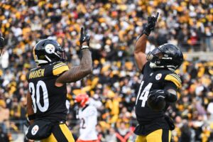Kenneth Gainwell #14 and Jaylen Warren #30 of the Pittsburgh Steelers celebrate a first quarter touchdown against the Cincinnati Bengals.