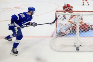 Nikita Kucherov #86 of the Tampa Bay Lightning scores against Devin Cooley #1 of the Calgary Flames.
