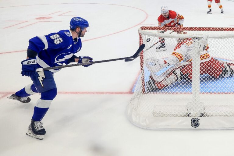 Nikita Kucherov #86 of the Tampa Bay Lightning scores against Devin Cooley #1 of the Calgary Flames.