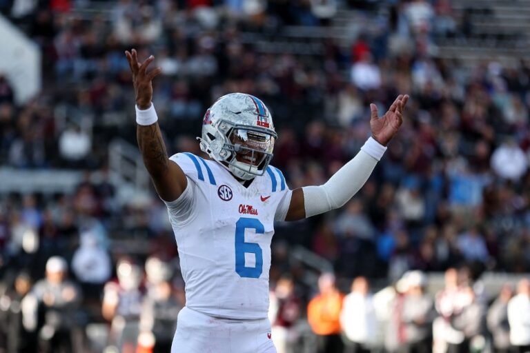 The cover for this College football odds bowls article shows Trinidad Chambliss #6 of the Mississippi Rebels reacting against the Mississippi State Bulldogs.